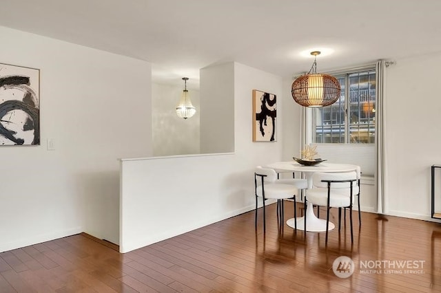 dining area with dark hardwood / wood-style floors