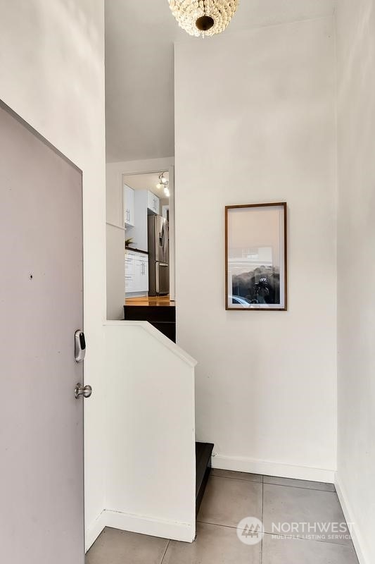 hallway with tile patterned floors