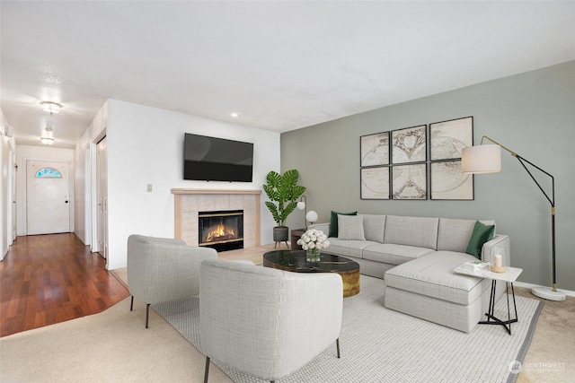 carpeted living room with a tile fireplace