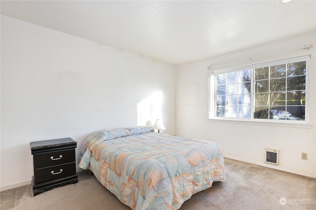 carpeted bedroom featuring heating unit