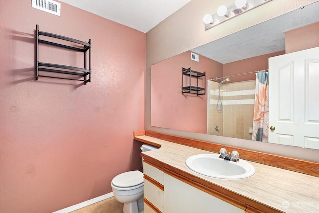 bathroom with a shower with curtain, vanity, tile patterned flooring, and toilet