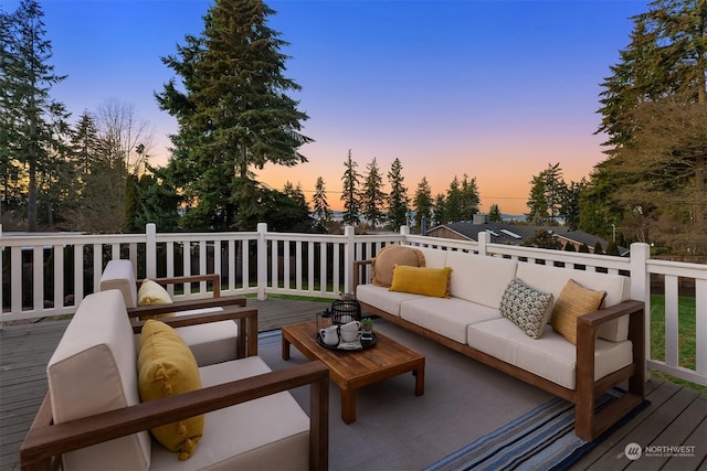 deck at dusk with an outdoor living space