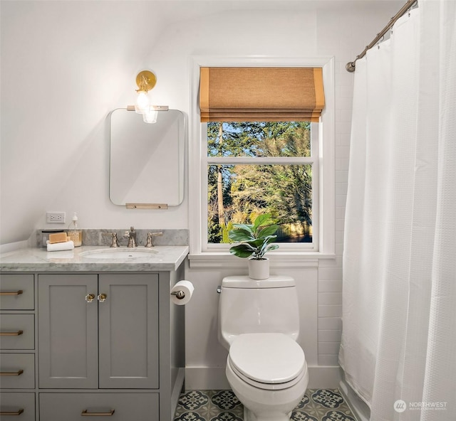 bathroom with vanity, a shower with curtain, tile patterned floors, and toilet