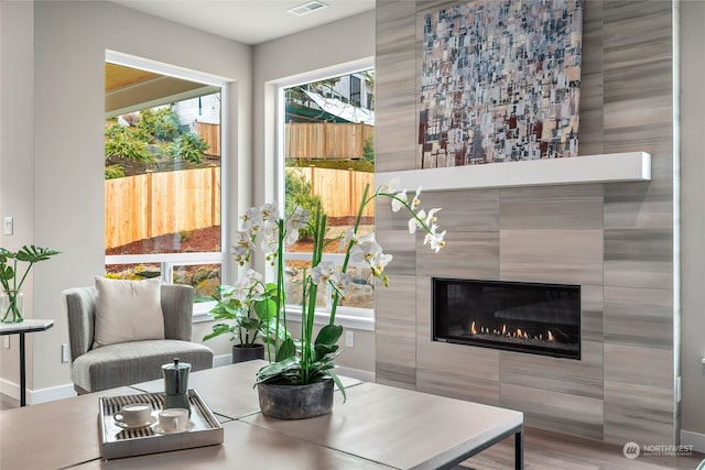 living room featuring visible vents, a fireplace, and baseboards