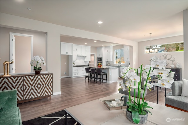 living room featuring recessed lighting, a chandelier, and wood finished floors