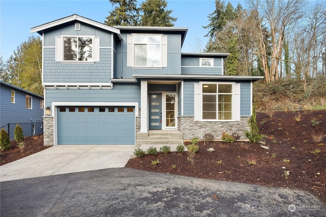 view of front of property featuring concrete driveway, an attached garage, and stone siding