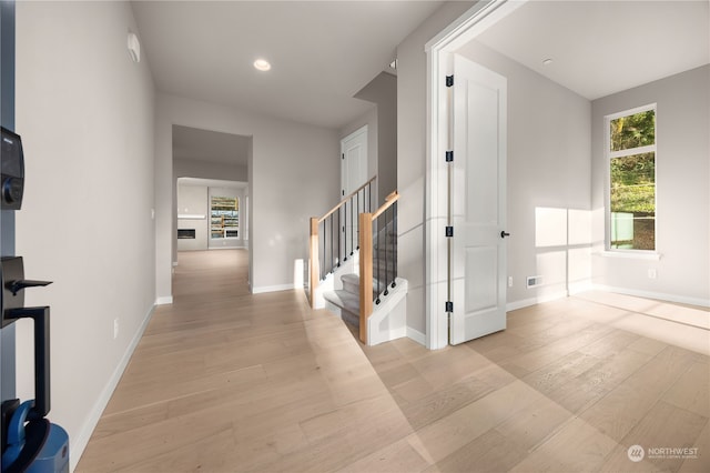 hall with visible vents, light wood-style flooring, recessed lighting, stairway, and baseboards