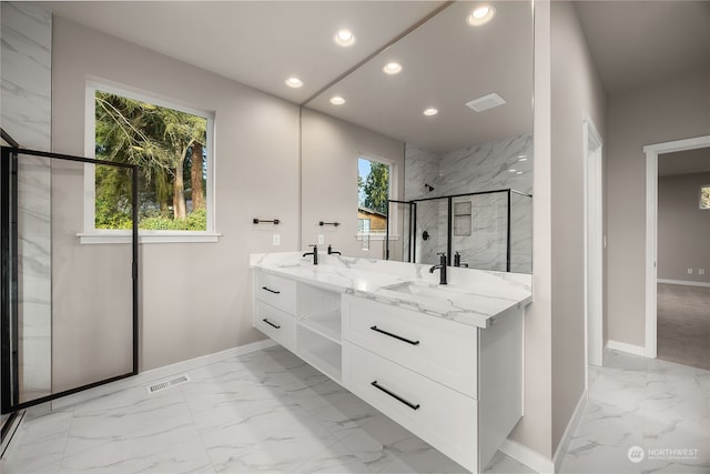 full bathroom with marble finish floor, a sink, recessed lighting, a marble finish shower, and double vanity