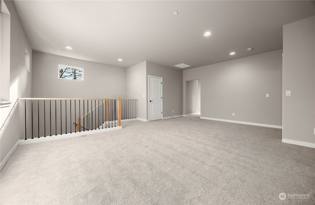 carpeted spare room featuring recessed lighting and baseboards