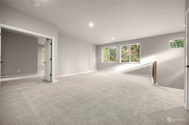 spare room featuring carpet flooring, recessed lighting, and a wealth of natural light