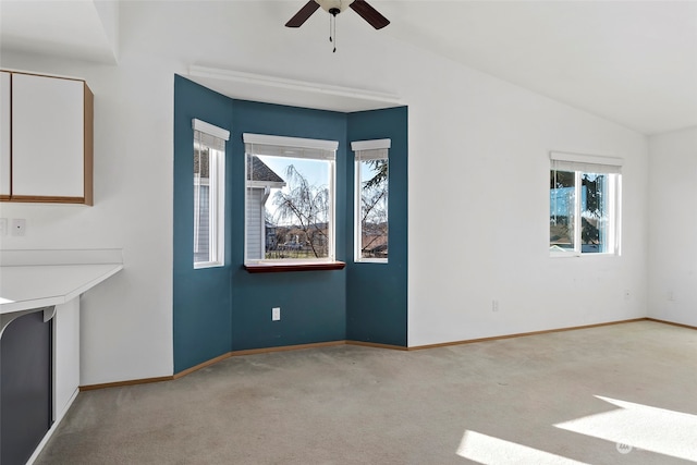 interior space featuring light carpet, vaulted ceiling, and ceiling fan