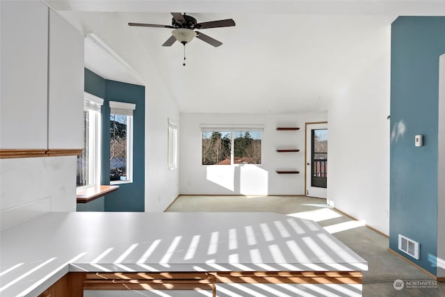 unfurnished living room with lofted ceiling and ceiling fan