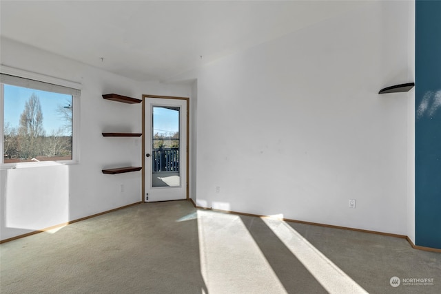 unfurnished room featuring light carpet