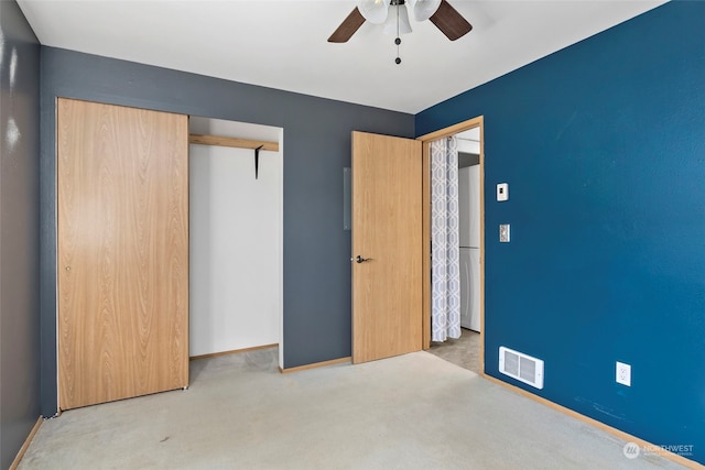 unfurnished bedroom with light carpet, a closet, and ceiling fan