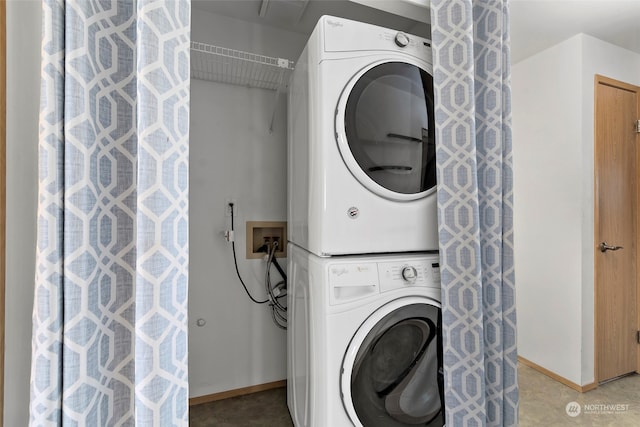 clothes washing area with stacked washer / dryer