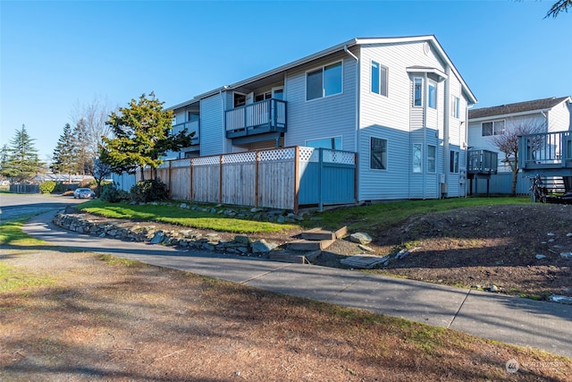 view of side of home with a balcony