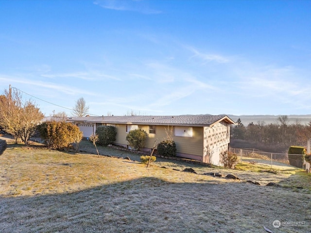 single story home featuring a garage and a front lawn