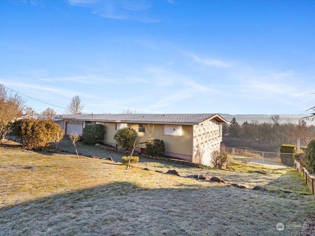 view of front of home featuring a garage and a front lawn