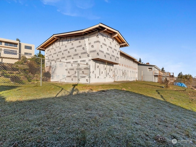 rear view of property featuring a yard