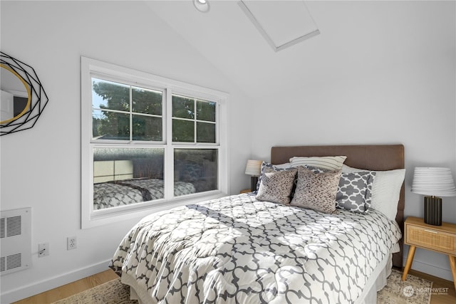 bedroom with hardwood / wood-style flooring and vaulted ceiling