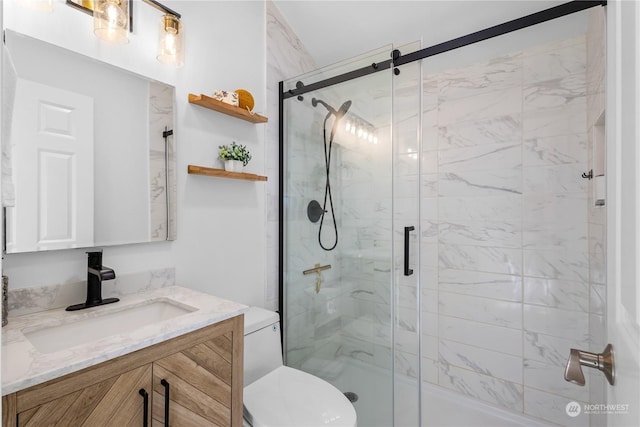 bathroom with vanity, an enclosed shower, and toilet