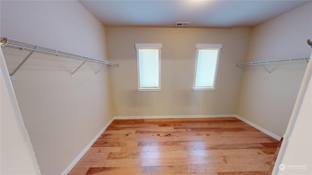 walk in closet featuring light hardwood / wood-style flooring