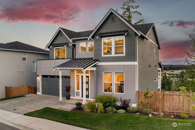 view of front of property with a garage and a lawn