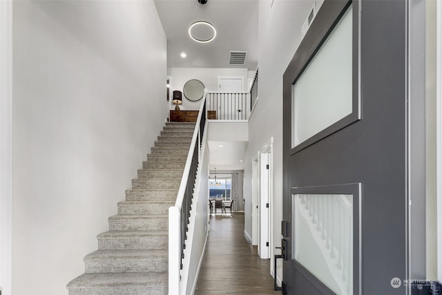 stairs featuring hardwood / wood-style floors