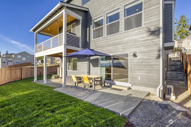 back of property featuring a yard and a patio area