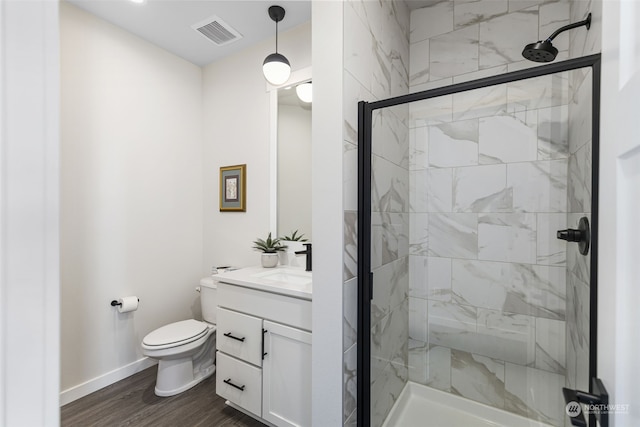 bathroom with vanity, wood-type flooring, an enclosed shower, and toilet