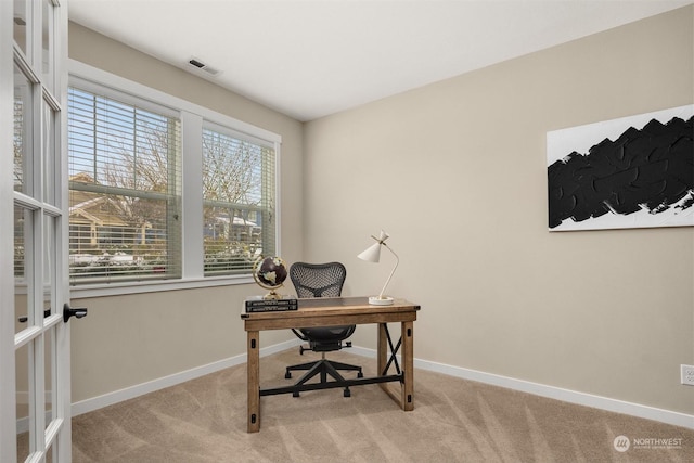 office area featuring light colored carpet