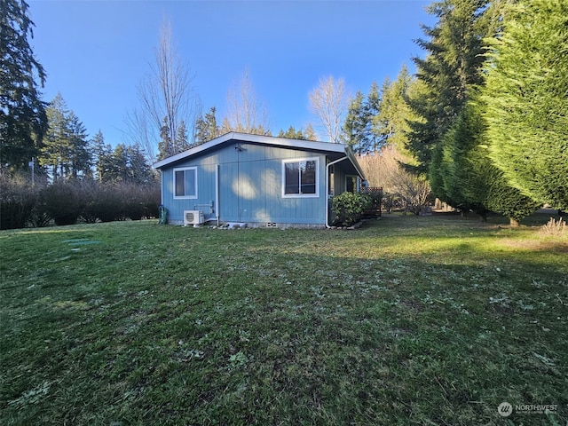 view of side of property with a yard