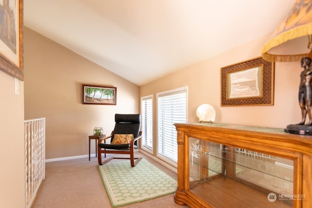 sitting room with lofted ceiling and light colored carpet