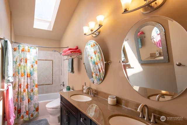 full bathroom with shower / tub combo, vanity, vaulted ceiling with skylight, and toilet