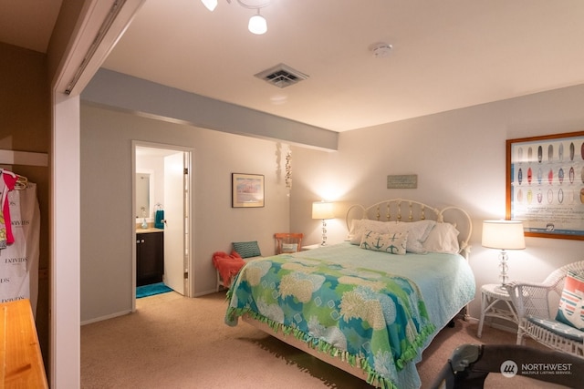 bedroom with light carpet and ensuite bath