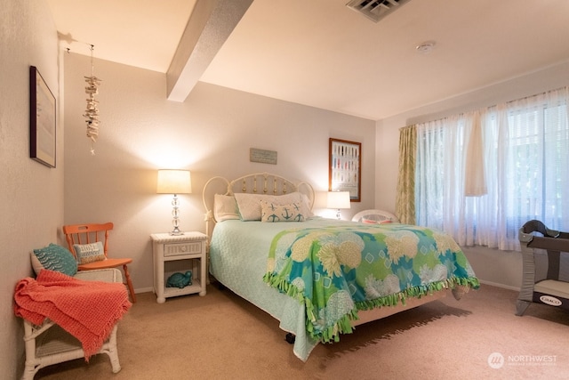 bedroom with beamed ceiling and carpet