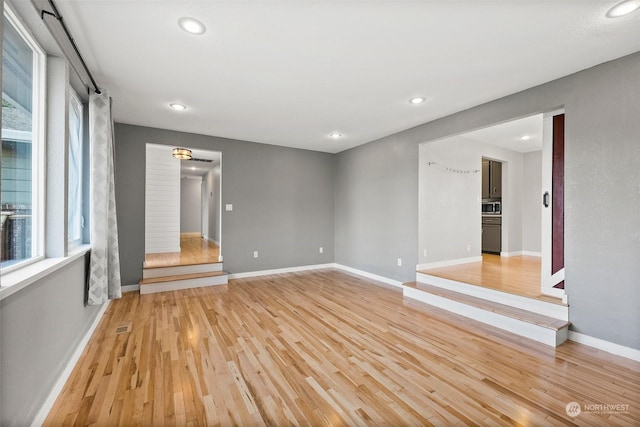 spare room with light wood-type flooring