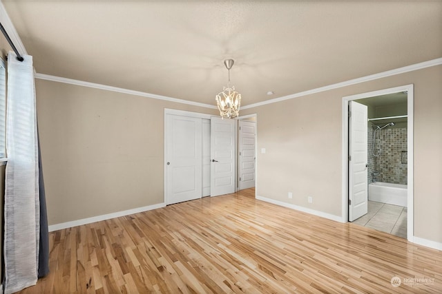 unfurnished bedroom with connected bathroom, crown molding, and light hardwood / wood-style flooring