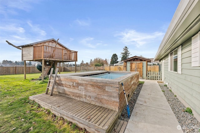 exterior space featuring a fenced in pool, a lawn, and a shed