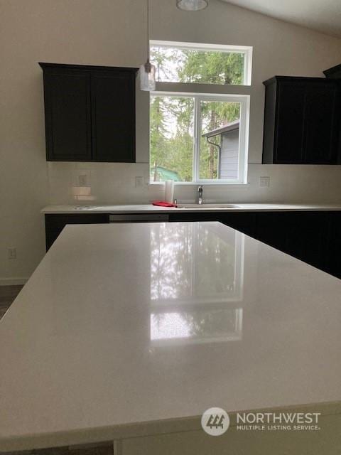 kitchen with lofted ceiling and sink