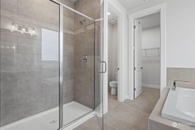 full bathroom featuring tile patterned flooring, separate shower and tub, sink, and toilet