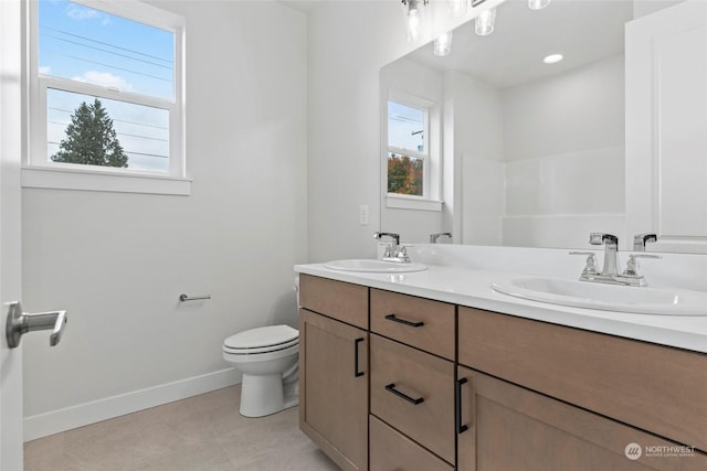 bathroom with tile patterned floors, vanity, and toilet