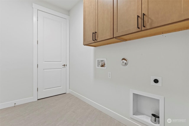 washroom featuring gas dryer hookup, cabinets, washer hookup, and hookup for an electric dryer