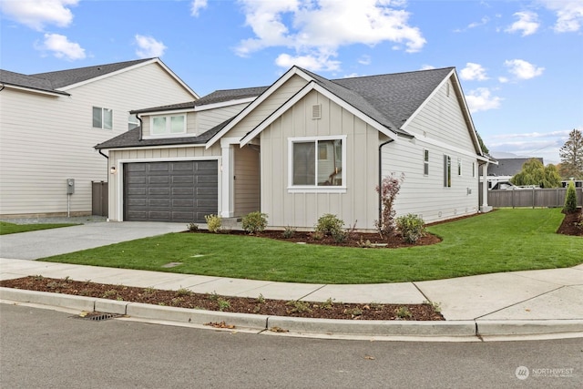 view of front of property featuring a garage and a front lawn