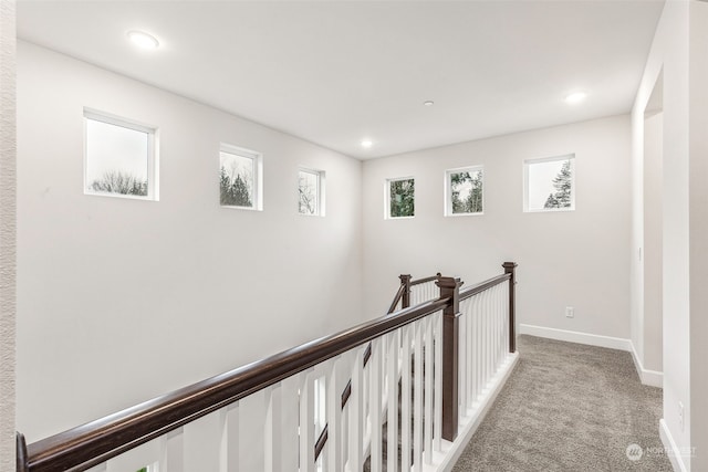 hall featuring light colored carpet