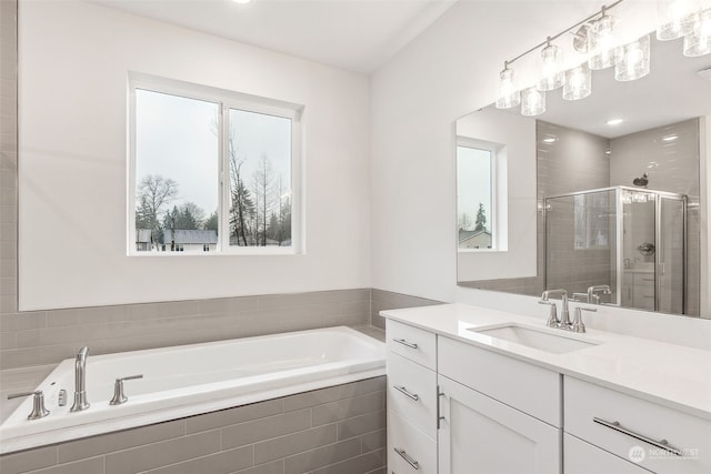 bathroom with vanity and separate shower and tub