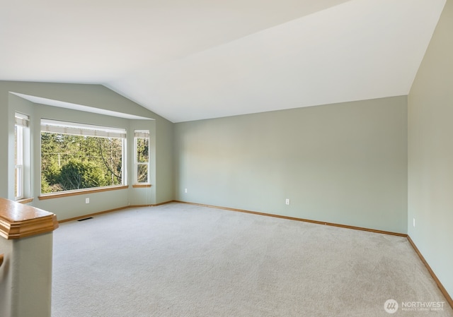 interior space featuring visible vents, carpet, and vaulted ceiling