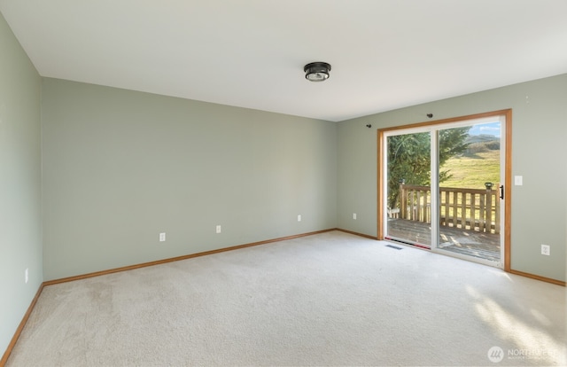 unfurnished room featuring visible vents, baseboards, and carpet flooring