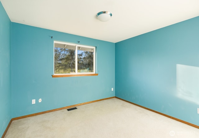 empty room featuring visible vents, baseboards, and carpet flooring