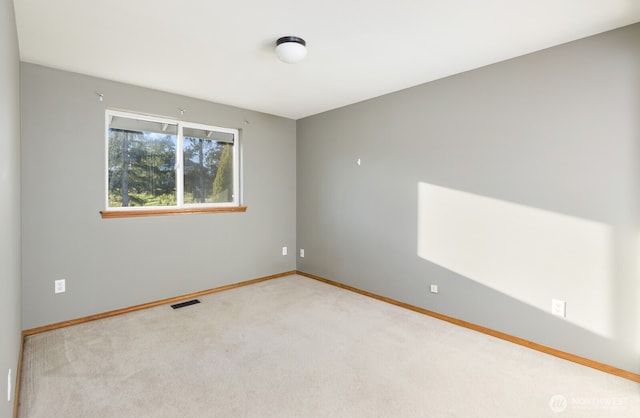 unfurnished room with baseboards, visible vents, and carpet floors